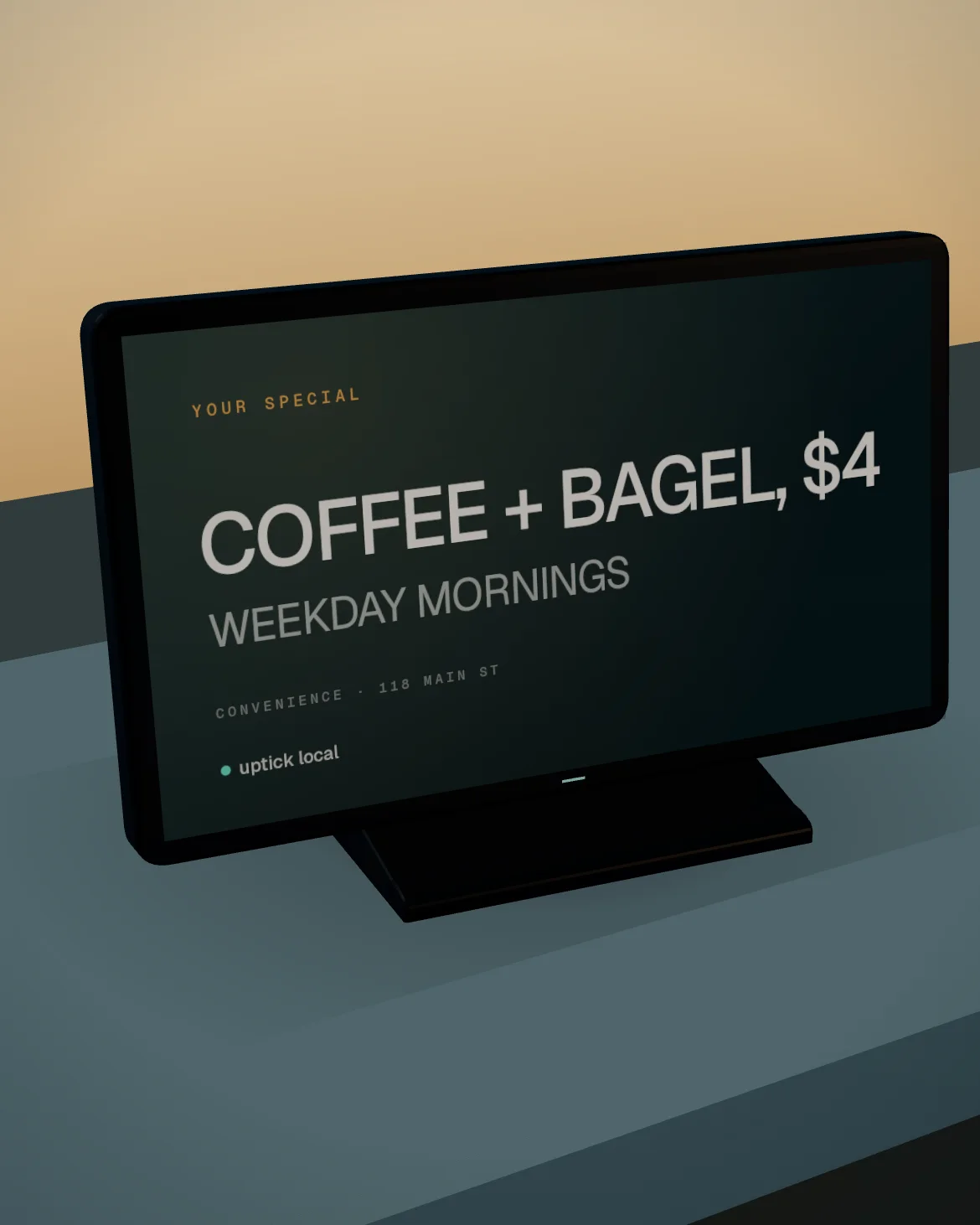 The Uptick screen on the convenience store's counter: a thin dark 21-inch display on a low foot, showing the store's own special.